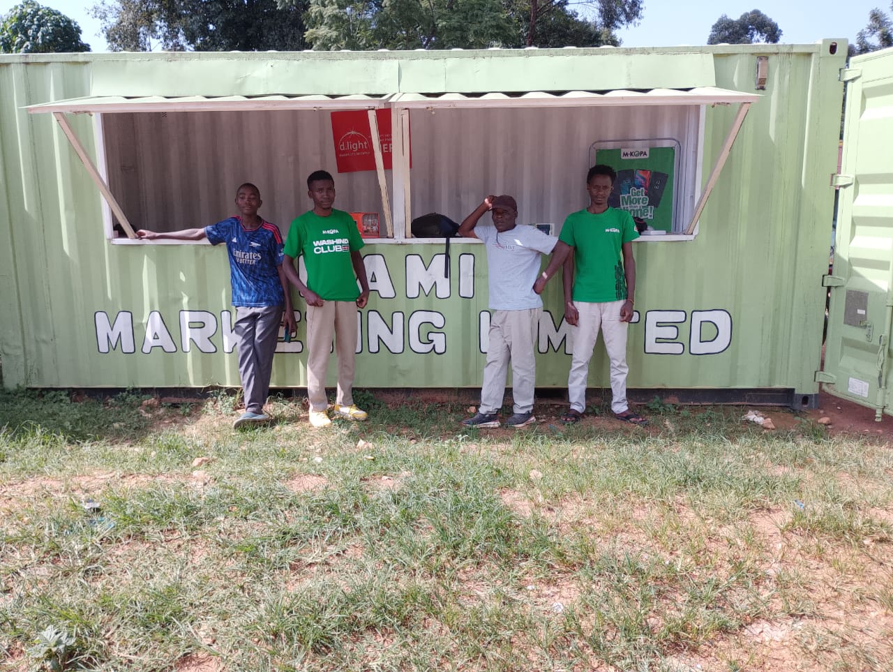 Lami Marketing Limited team outside the container shop
